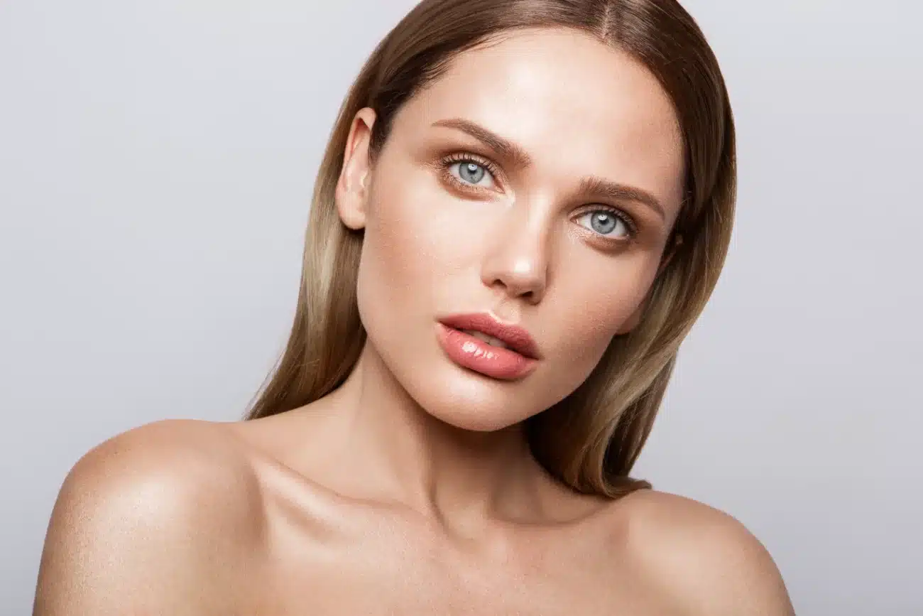 blepharoplasty eyelid featured image. Beauty portrait of model with natural make up. Fashion shiny highlighter on skin sexy gloss lips make up